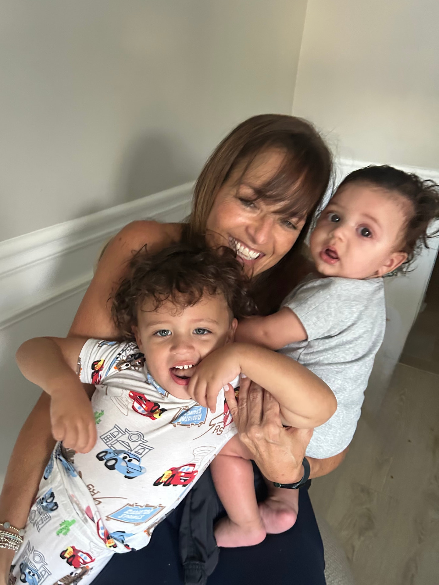 Trish smiling with her two grandsons