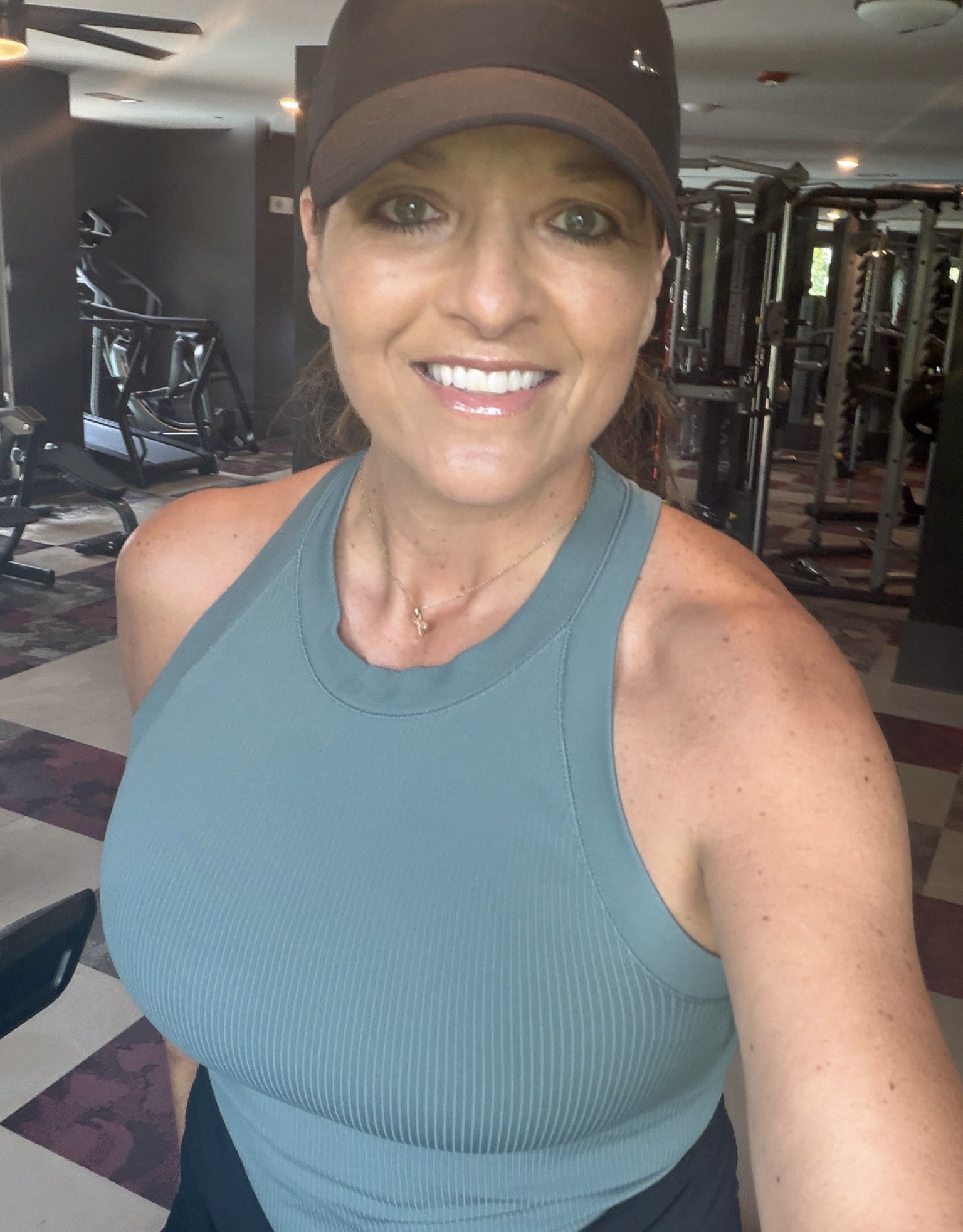 Trish wearing a green workout top in the gym